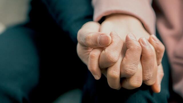 Two people holding hands